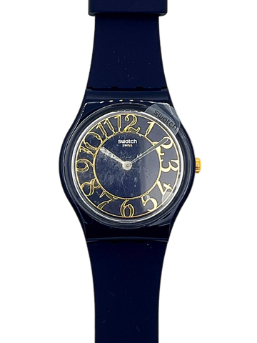 Swatch Swiss Sport watch featuring a dark navy blue silicone strap, a matching dark blue dial, and gold-tone Arabic numerals and hands.