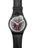 A Swatch wristwatch with a black leather strap, black case, and a dark brown textured dial with white numerals and hands.