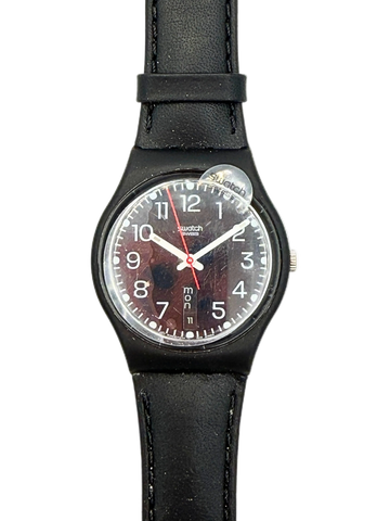 A Swatch wristwatch with a black leather strap, black case, and a dark brown textured dial with white numerals and hands.