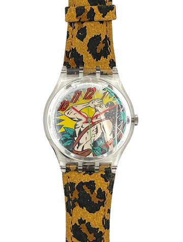 A wristwatch with a clear round case, a colorful illustrated dial, and a tan and black leopard-print strap, shown on a plain white background.