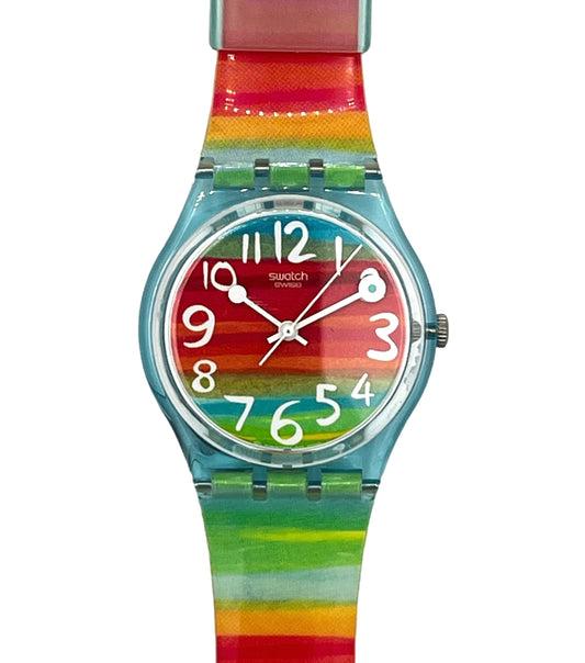 Swatch watch with a colorful rainbow striped strap and a matching multicolor dial on a white background.