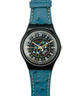 Watch with blue strap and black dial on a white background