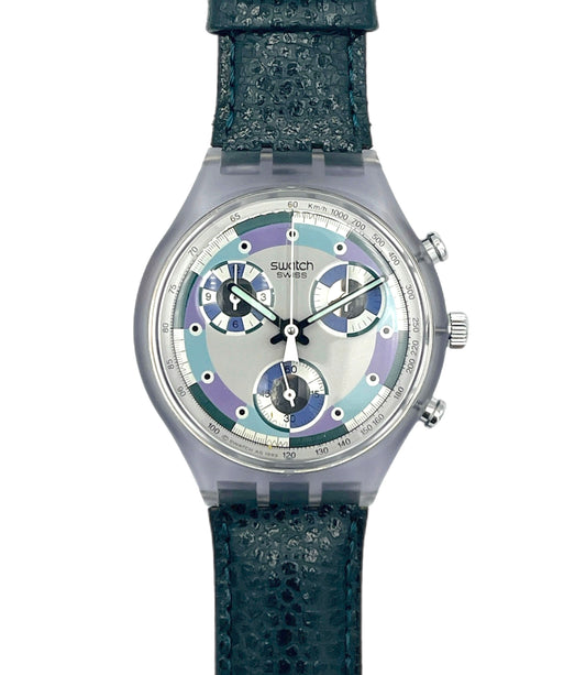 Swatch watch with a green strap and multicolor face on a white background