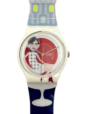 A Swatch 'Baby' watch featuring a white case, a colorful dial with a cartoon pin-up girl, and a patterned strap with blue, white, and red sections.