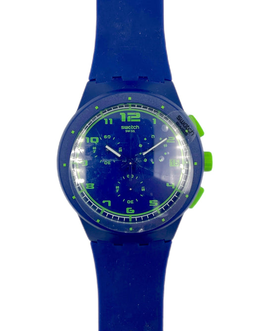Blue Swatch watch with green accents on a white background