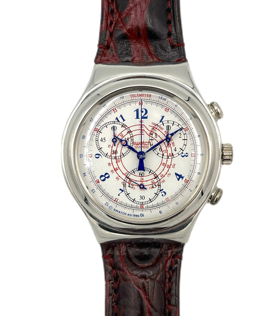 Watch with a detailed face and red and black strap on a white background
