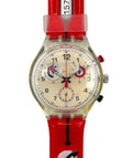 Wristwatch with red strap and clear case on a white background