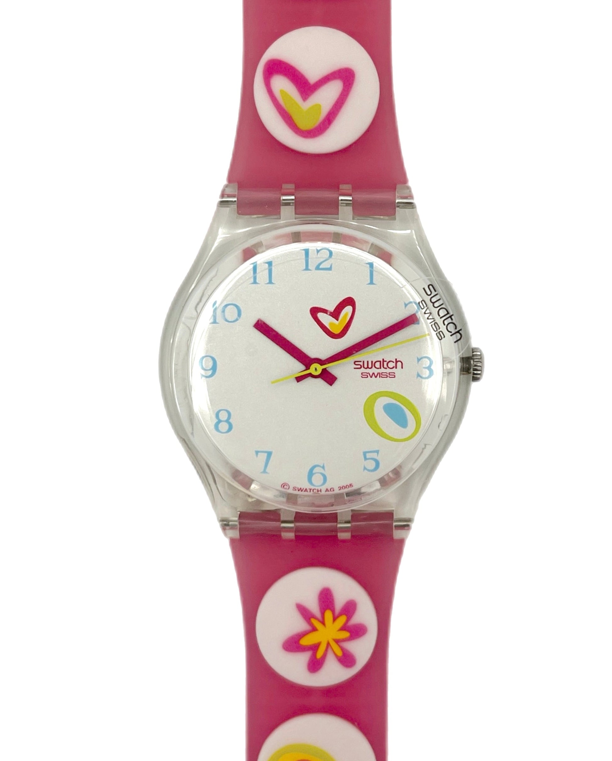 Swatch watch with colorful dial and pink strap on a white background