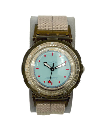Wristwatch with a light blue face and beige strap on a white background