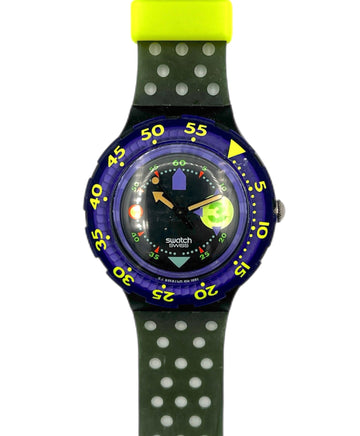 Swatch watch with green polka dot strap and blue case on white background