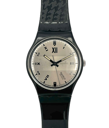 Black wristwatch with a patterned strap on a white background