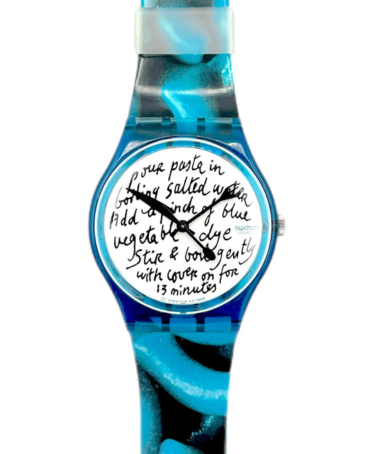 Wristwatch with blue strap and white face displaying text on a white background