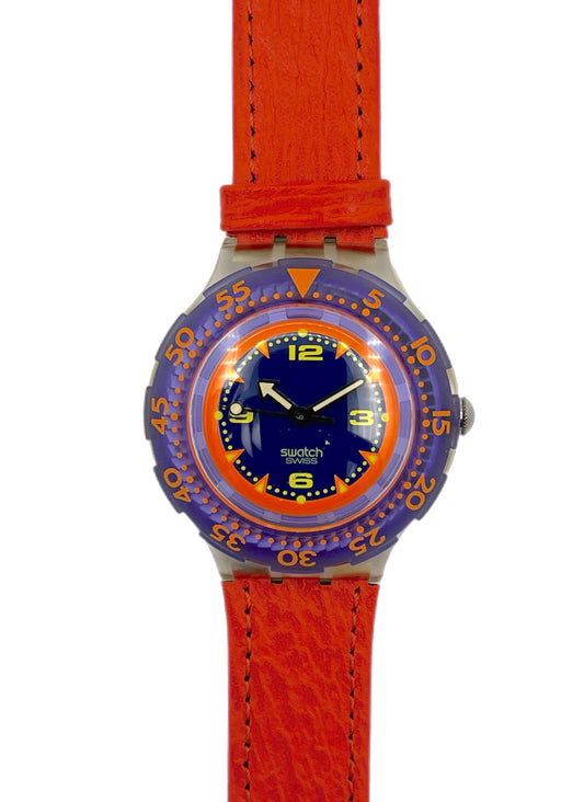 Watch with orange strap and blue dial on a white background