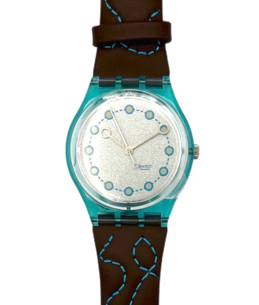 swatch Watch GL111 with a brown strap and turquoise accents on a silver dial