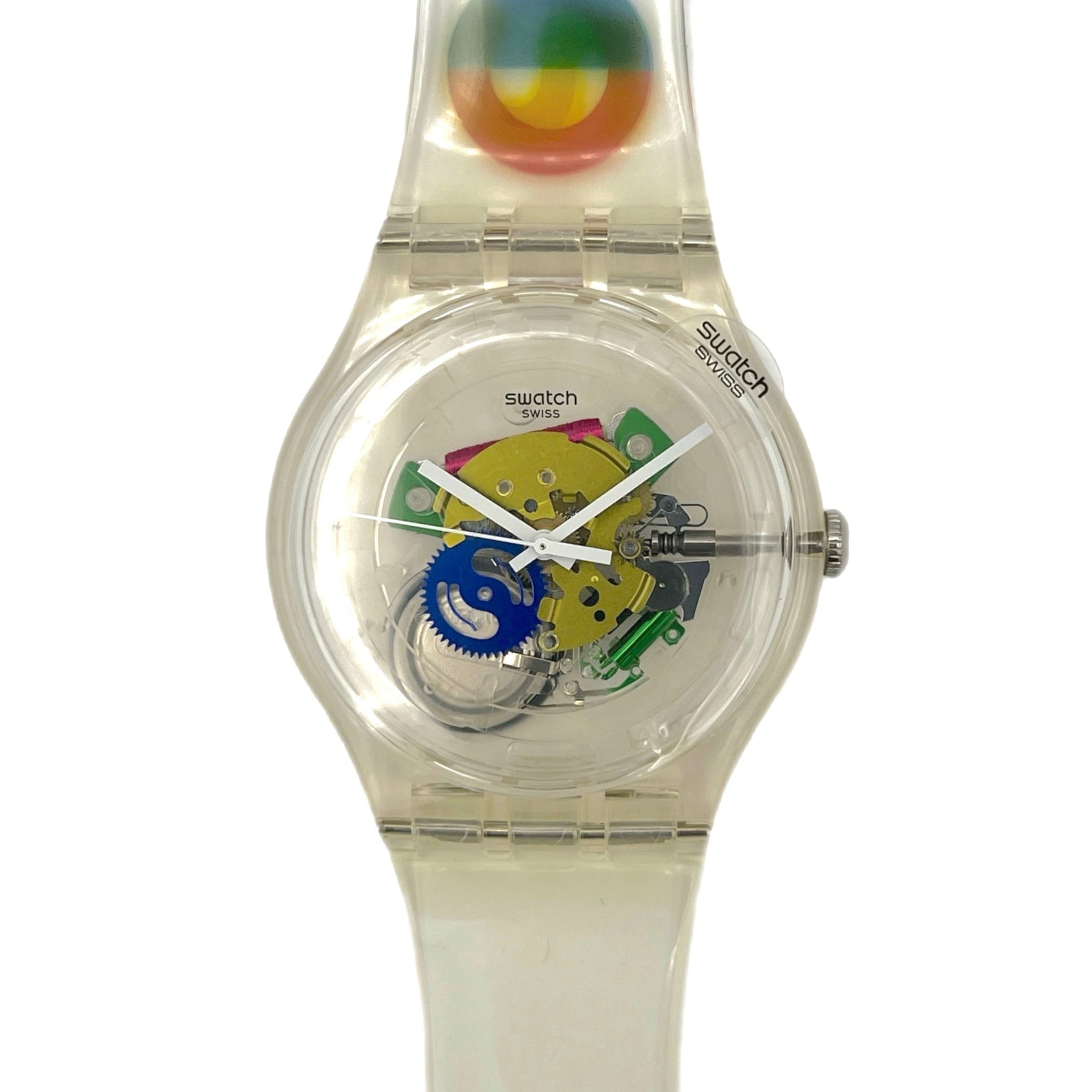 Clear Swatch watch with colorful face and Milano 2015 design on a white background