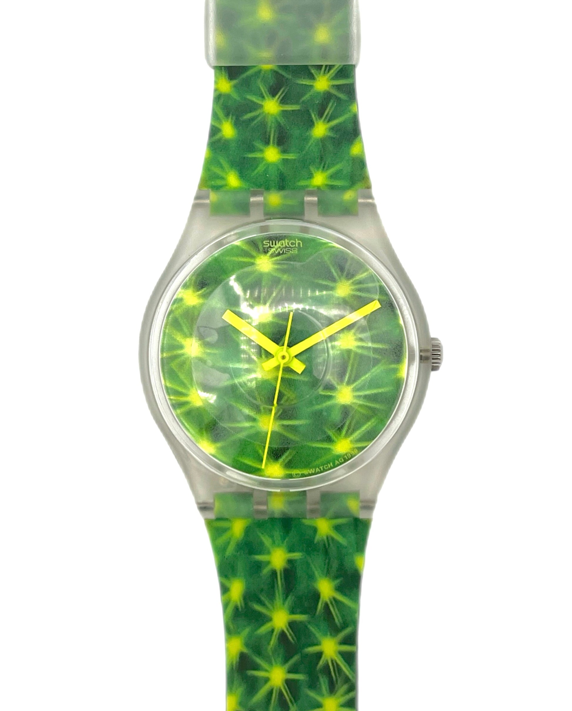 Green and yellow patterned watch with a clear strap on a white background