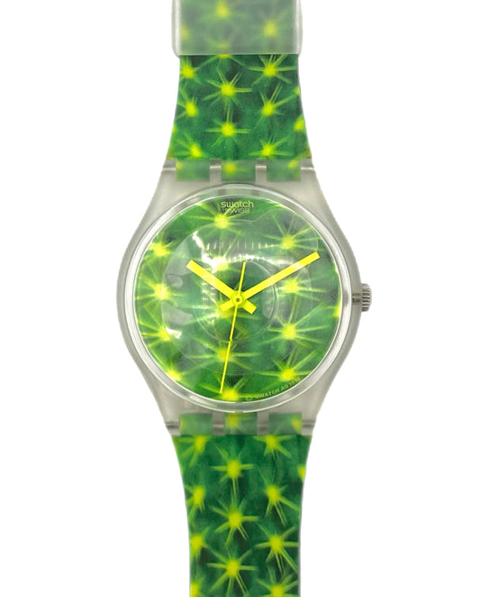 Green and yellow patterned watch with a clear strap on a white background