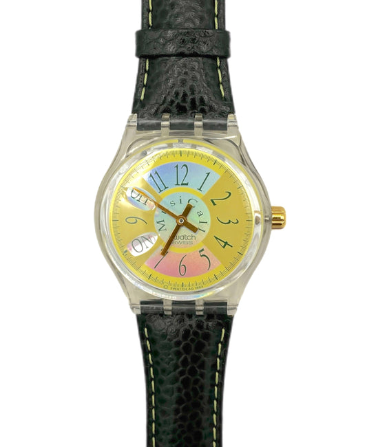 Watch with a colorful face and black strap on a white background
