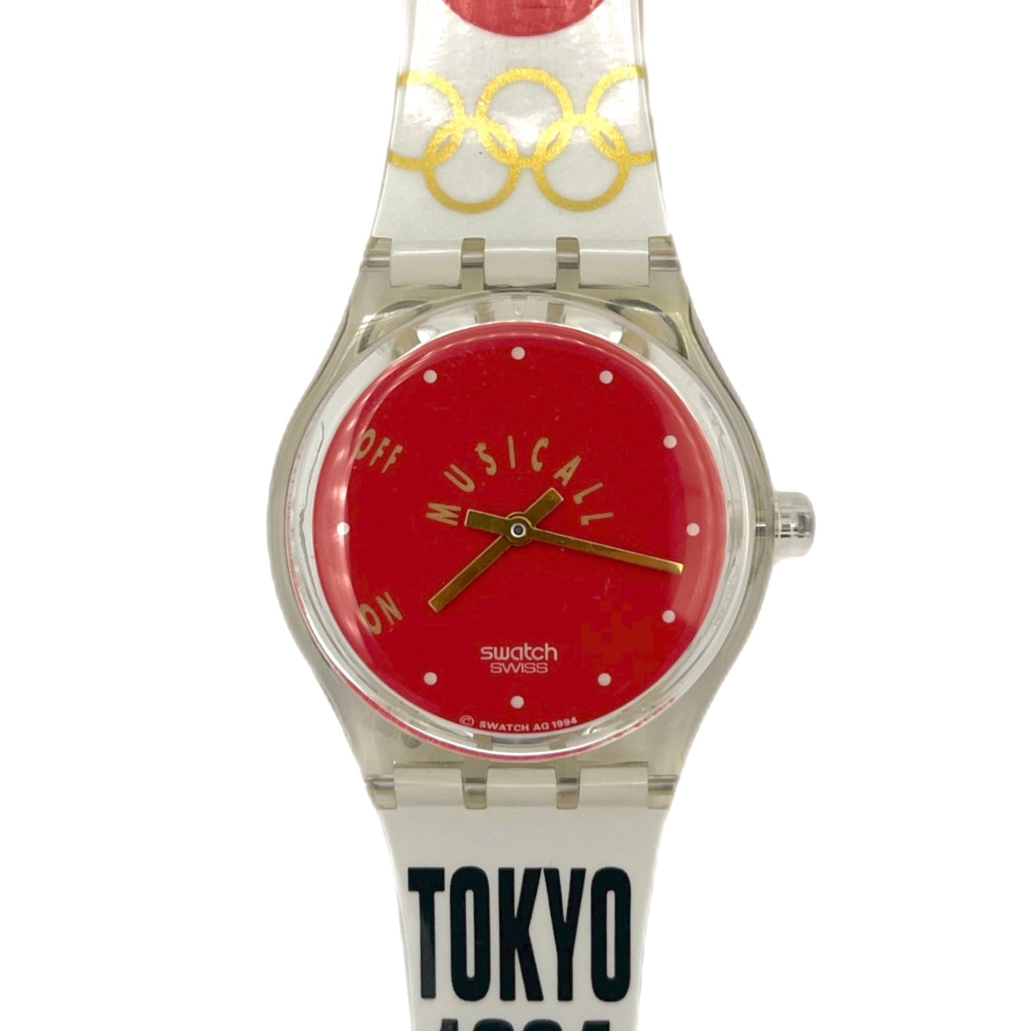 Watch with red face and white strap featuring 'TOKYO 1964' text on a white background