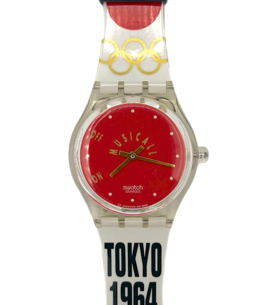 Watch with red face and white strap featuring 'TOKYO 1964' text on a white background