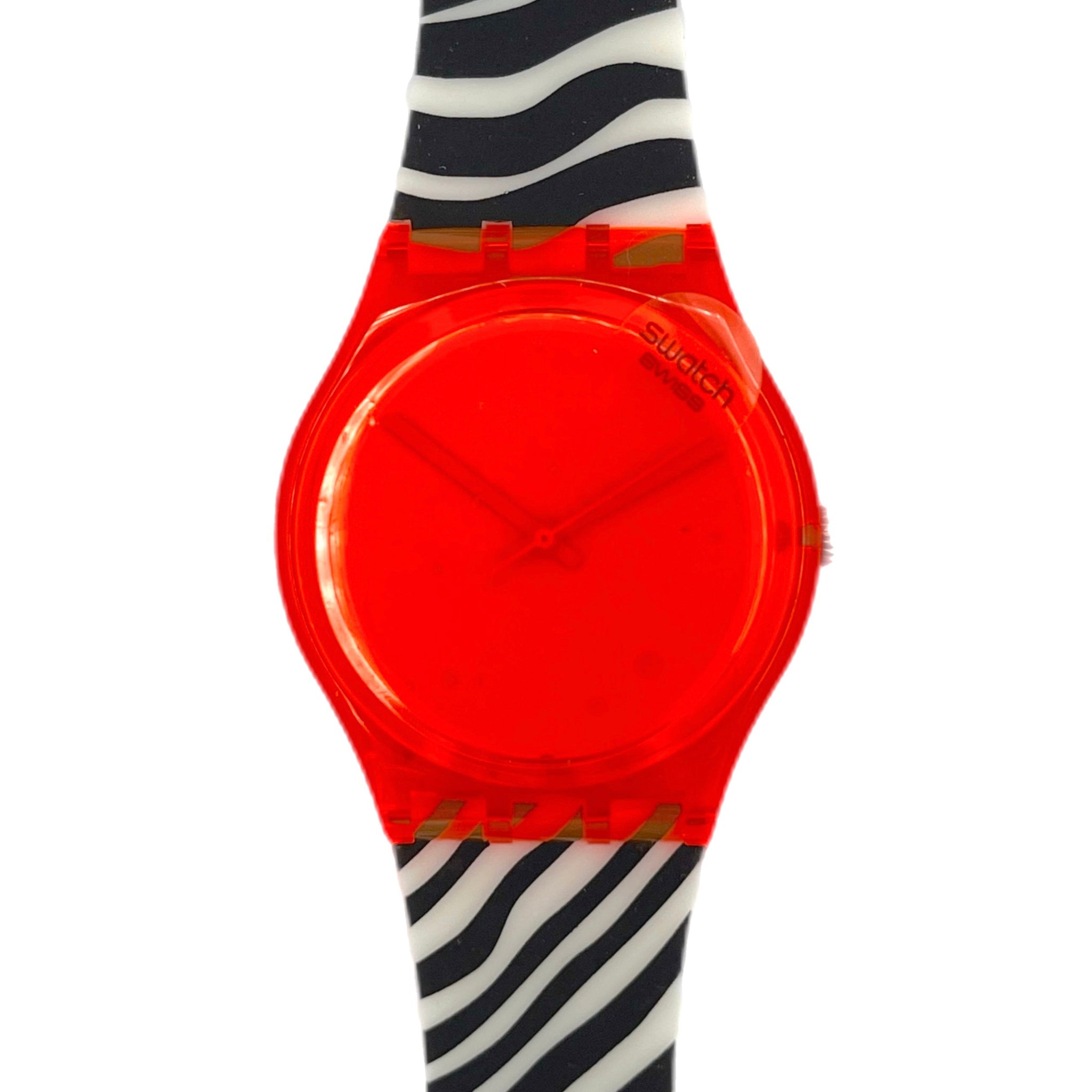 Neon orange Swatch watch on a black and white striped arm against a white background