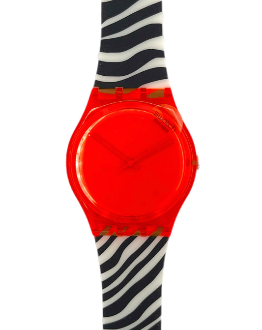 Neon orange Swatch watch on a black and white striped arm against a white background