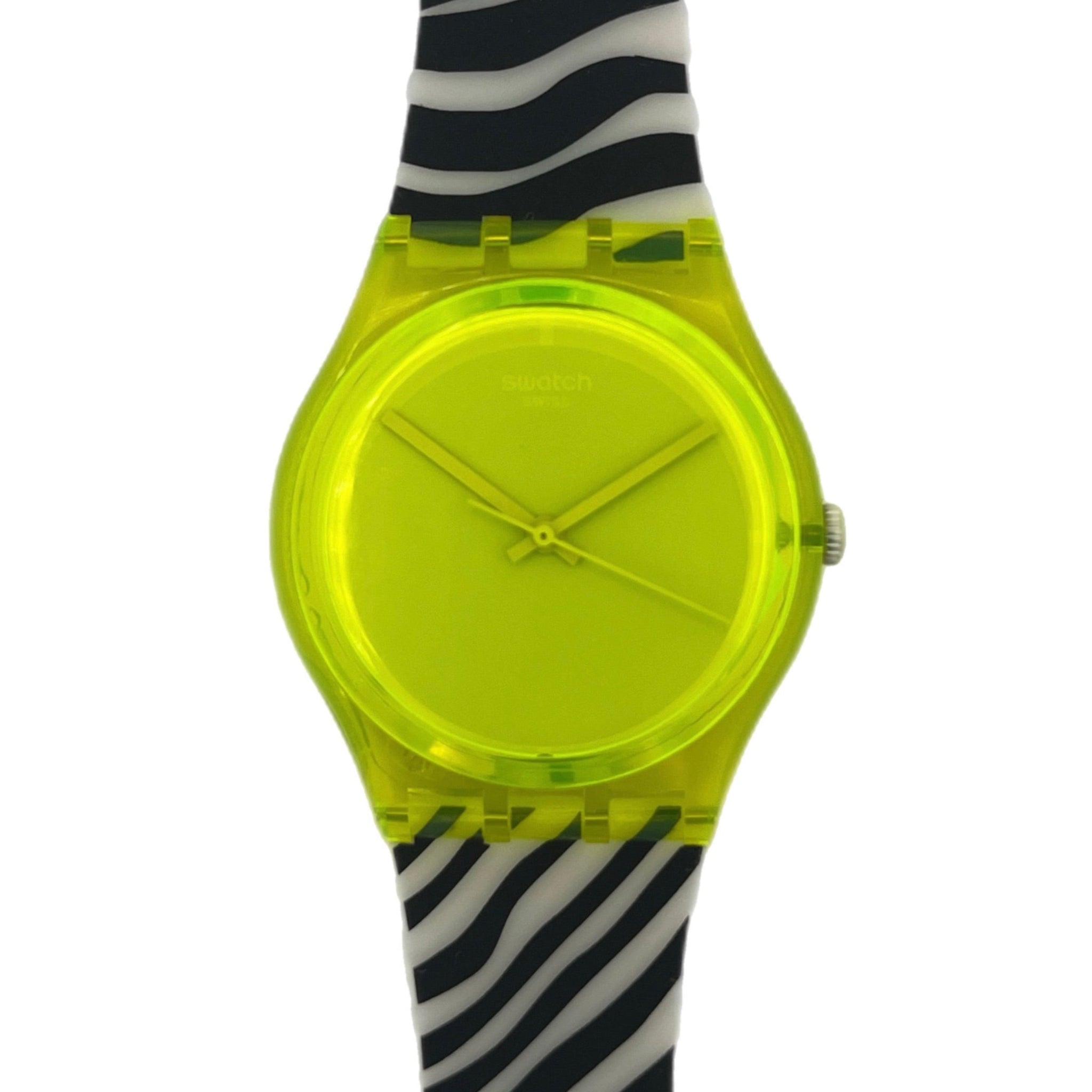 Swatch with a neon yellow face and black and white zebra pattern strap on a white background