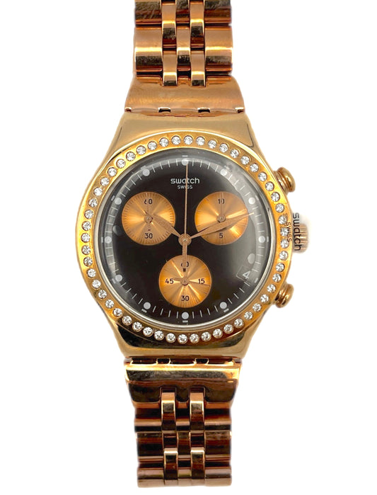 Gold watch with a black face and diamond-studded bezel on a white background