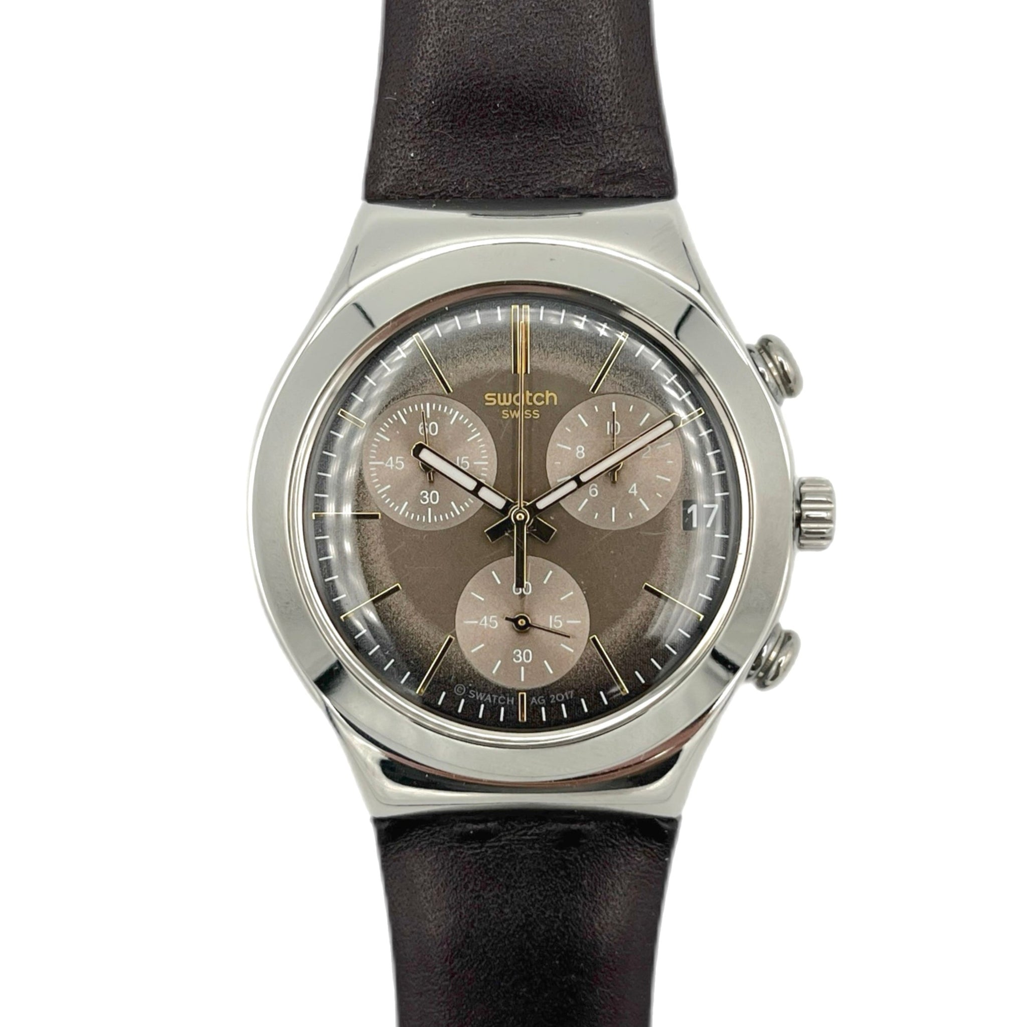 Swatch watch with black strap and brown dial on a white background