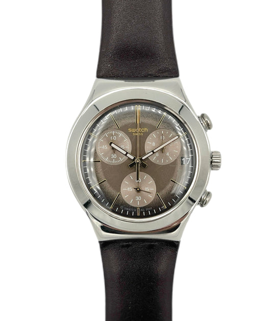 Swatch watch with black strap and brown dial on a white background