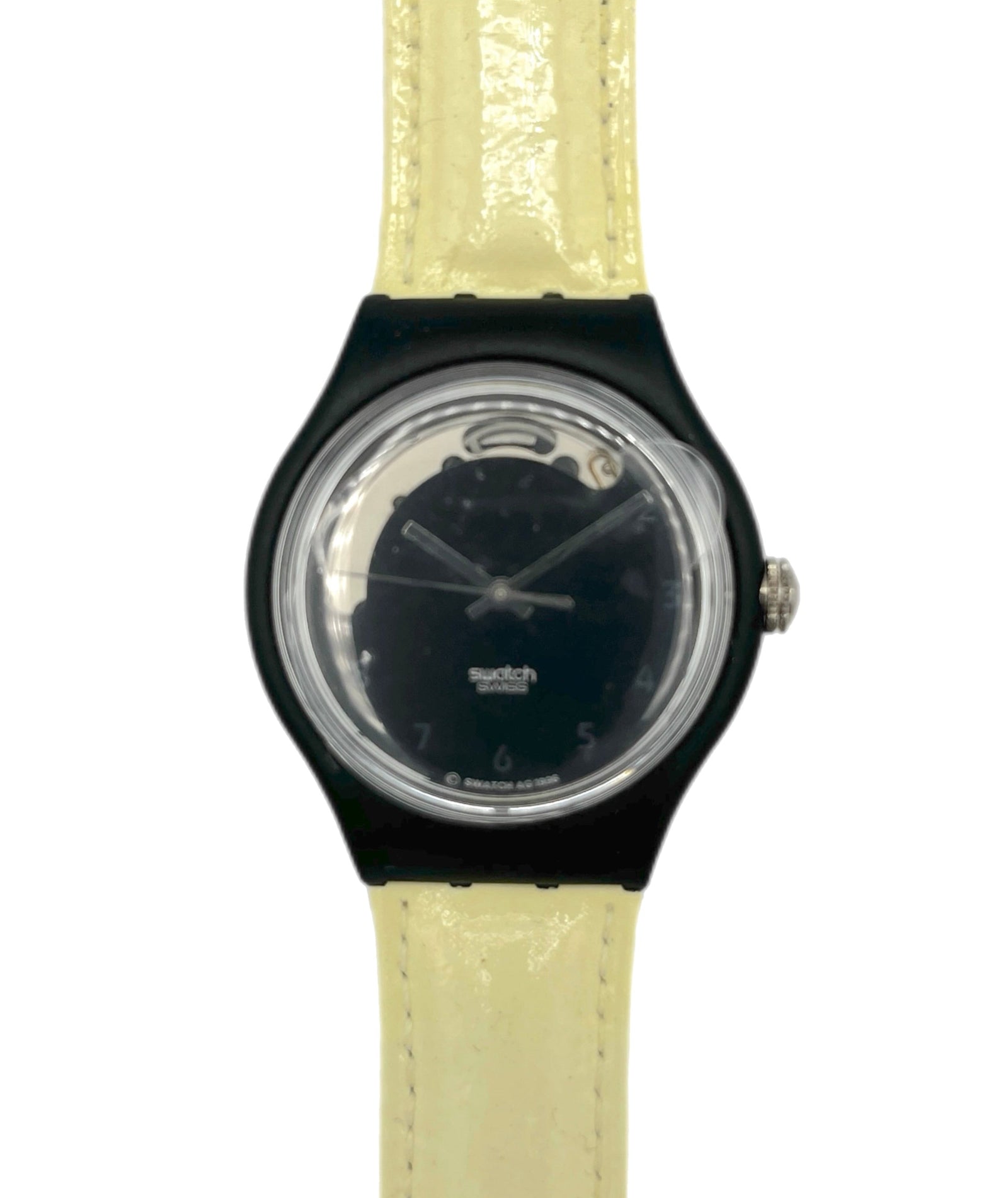Watch with black case and beige strap on a white background
