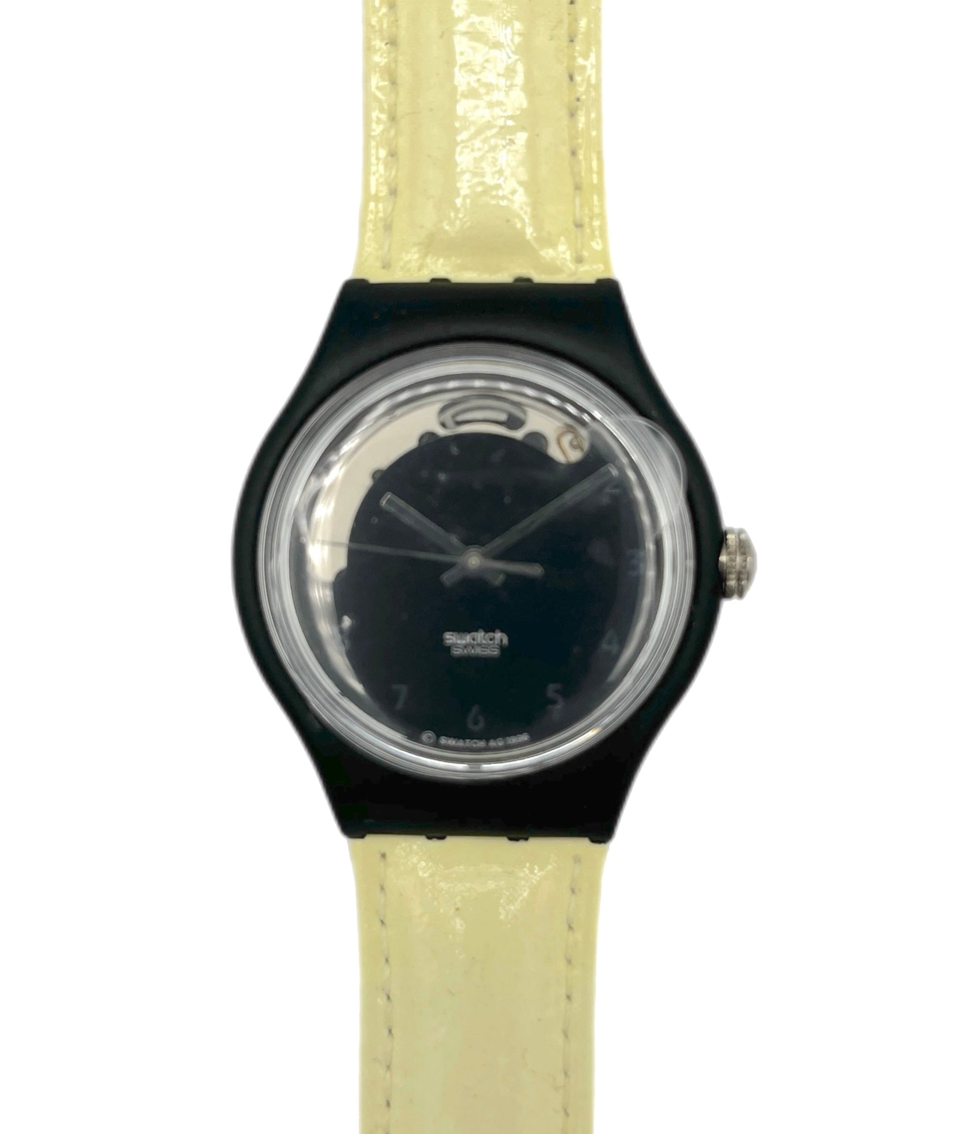 Watch with black case and beige strap on a white background