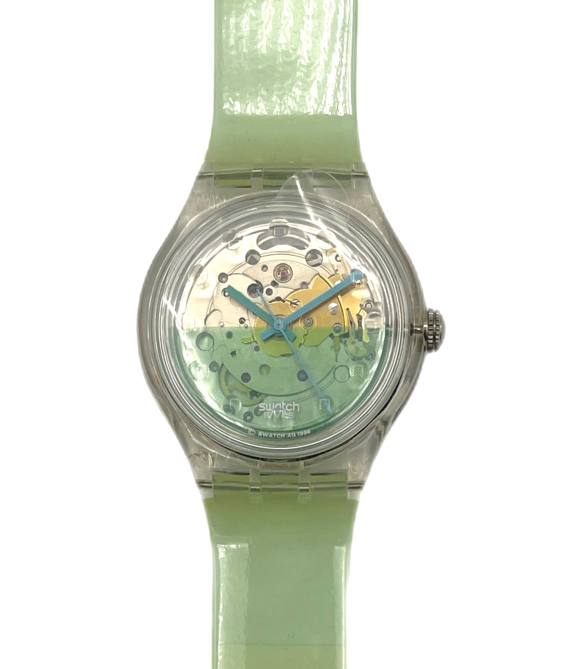 Green wristwatch with transparent case on a white background
