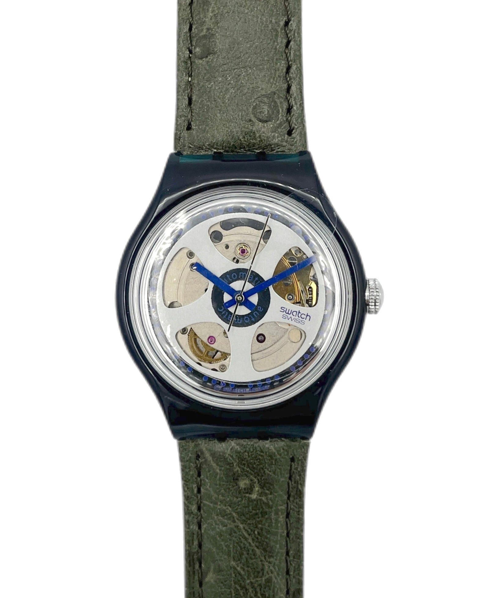 Watch with green strap and visible mechanism on a white background