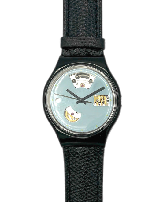 Swatch Automatic Watch with black strap and a mirror face on a white background