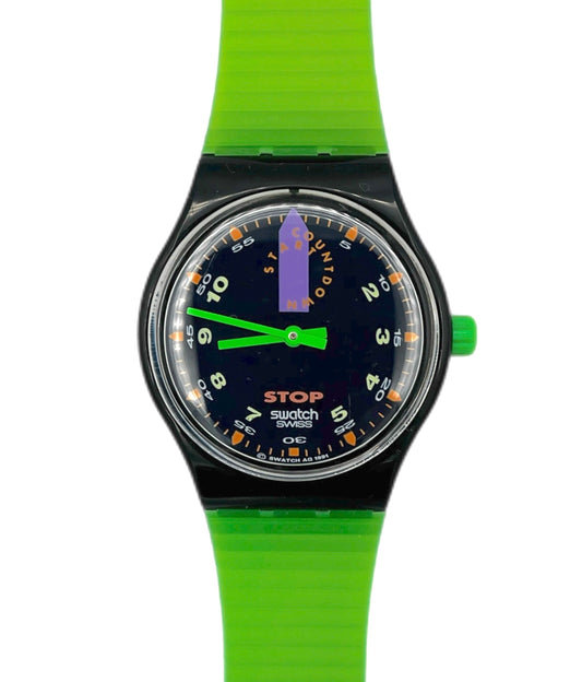 Swatch watch with green strap and black dial on a white background