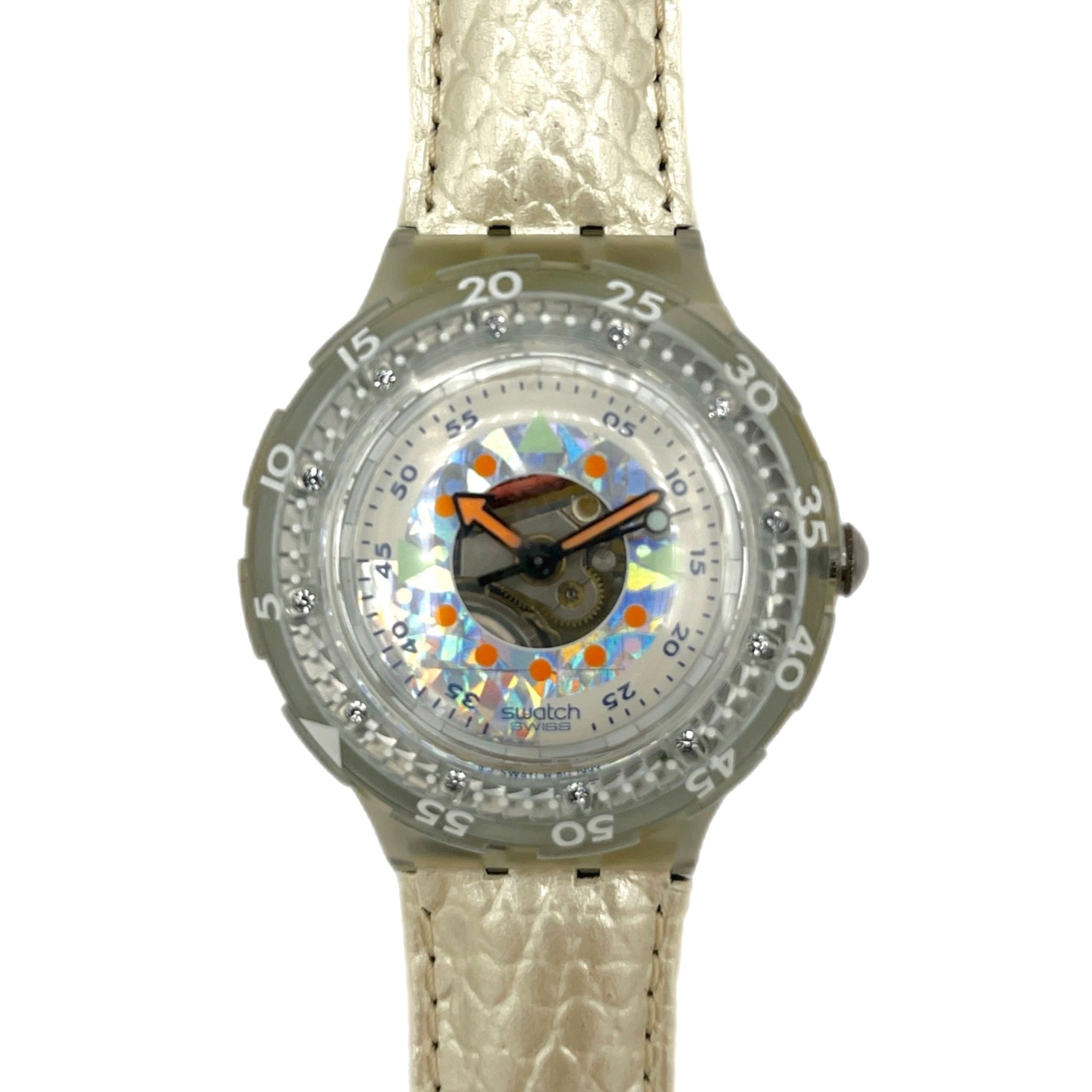 Wristwatch with a patterned face and beige strap on a white background