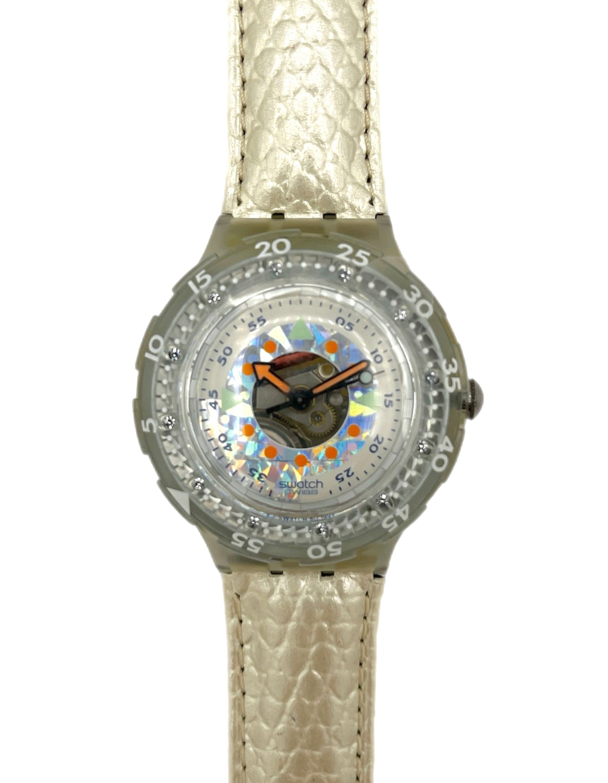 Wristwatch with a patterned face and beige strap on a white background