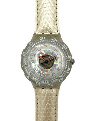 Wristwatch with a patterned face and beige strap on a white background