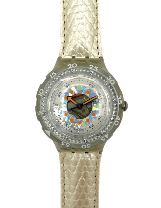 Wristwatch with a patterned face and beige strap on a white background