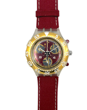 Wristwatch with red strap and gold case on a white background