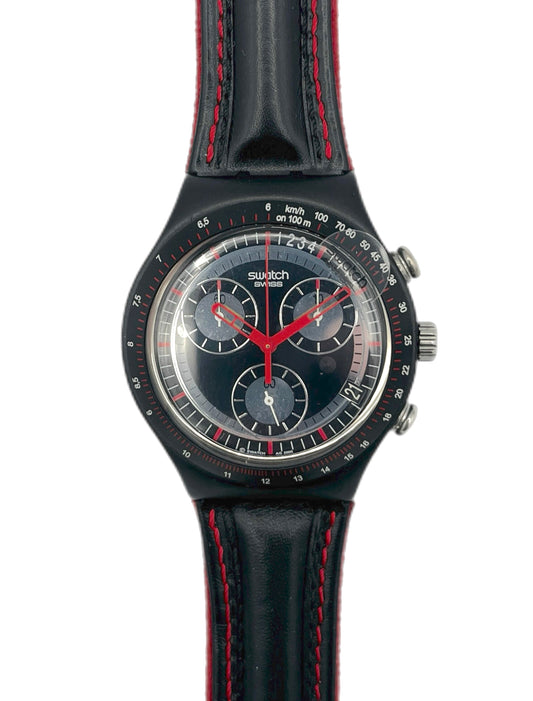 Black Swatch watch with red accents on a white background