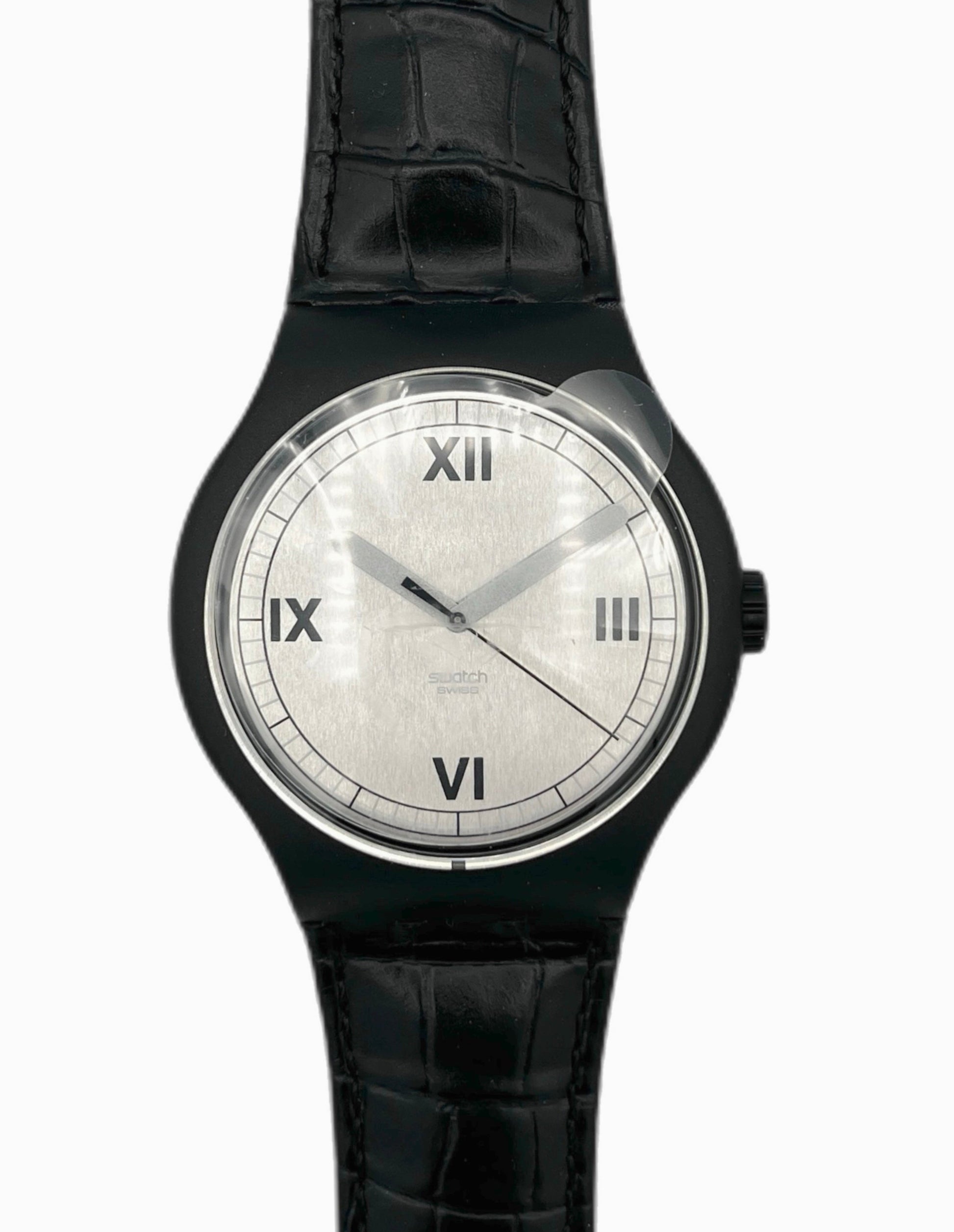 Black wristwatch with a white face on a white background