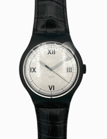 Black wristwatch with a white face on a white background