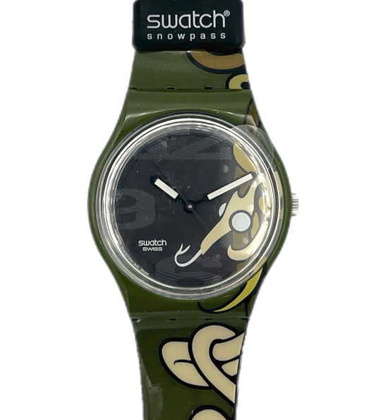 Swatch watch with green strap and black face on a white background