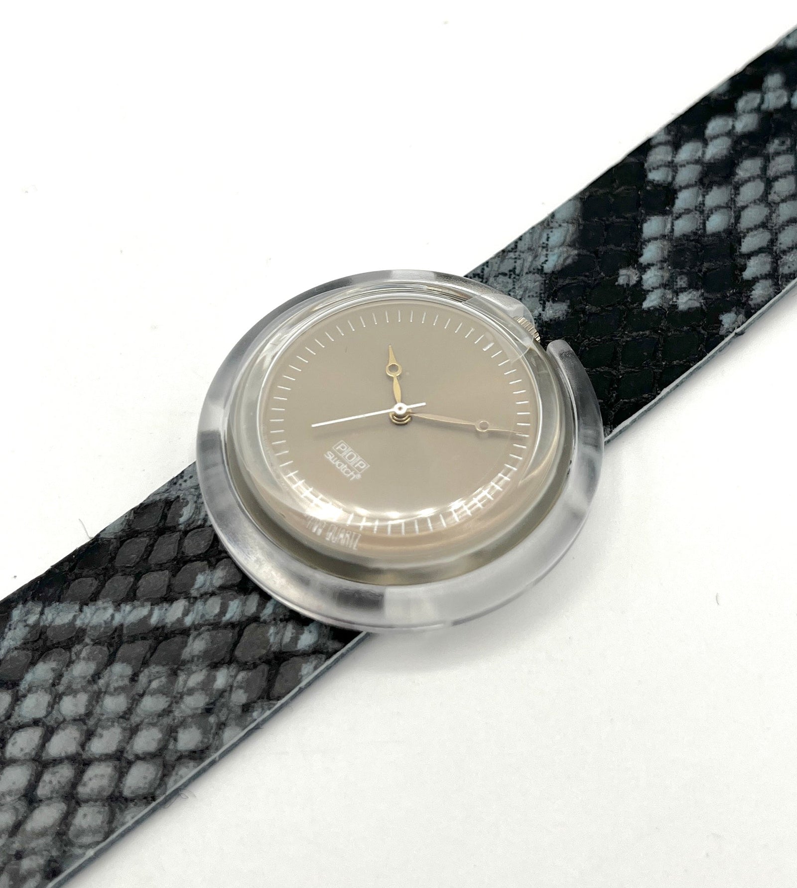 Watch with a patterned strap on a white background