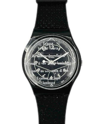 Black watch with a transparent face displaying text on a white background