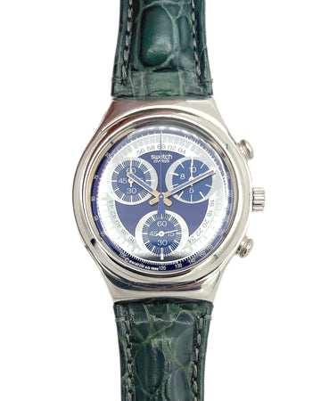 Swatch watch with green strap and blue face on a white background