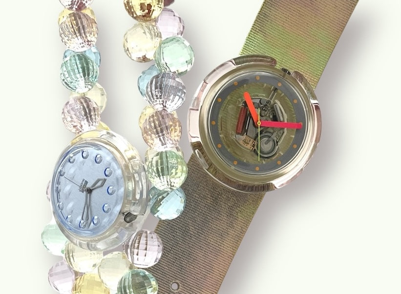 A new, unopened replacement band for a Pop Swatch watch, featuring a vibrant orange textile strap with a matching orange dial, packaged in a clear plastic case.