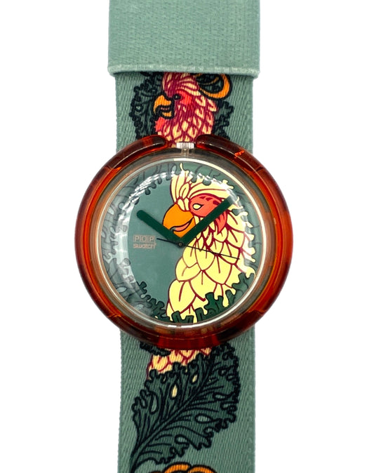 Watch with a colorful face design on a green strap with floral patterns